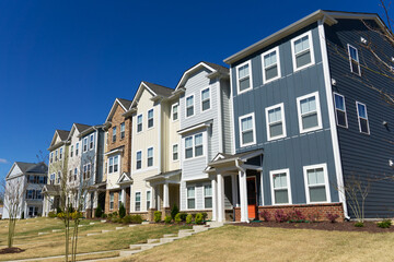 A row of attached residential suburban townhomes