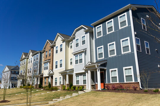 A row of attached residential suburban townhomes