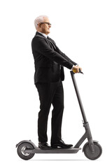 Mature businessman riding an electric scooter