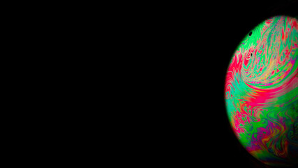 Bubbles macro. Globe planet earth in galaxy universe space with abstract sun on black background. Macro of oil mixed with water.