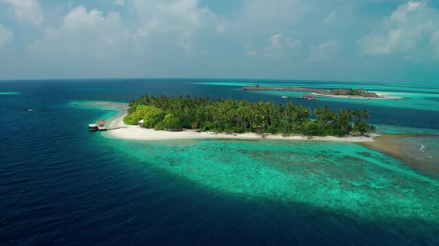 Aerial view of a tropical island in the Indian Ocean. Thinadhoo (Vaavu Atoll), Maldives