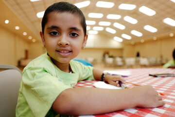 Happy and beautiful short hair preschool age girl enjoying different indoors children activities at...