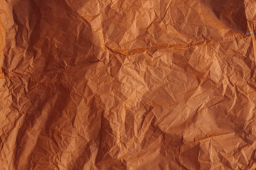 Texture of smooth crumpled paper of light chocolate color.