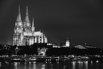 Fototapeta premium Cologne, Germany. View Of Cologne Cathedral. Catholic Gothic Cathedral In Night. UNESCO World Heritage Site. Black And White Colors