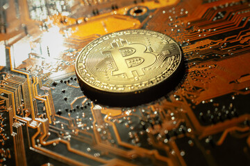 Electronic circuit blur. Bitcoin coin on electronic board