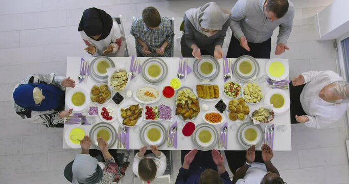 Family gathering eating dinner at home during Ramadan