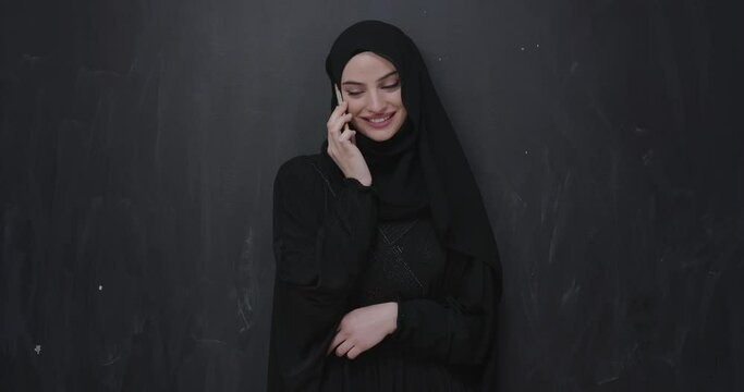 Modern Muslim woman using smart phone 