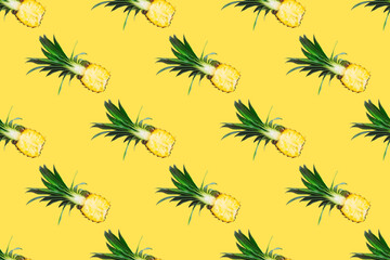 Seamless pattern of fresh pineapple halves isolated on yellow background.Top view