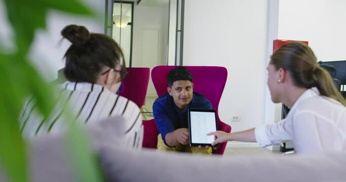 Business people connected on internet network with a tablet in a relax room in startup company