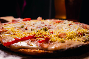 melted mozzarella cheese pizza with dark background