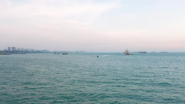 Drone shot of boat moving in Singapore anchorage