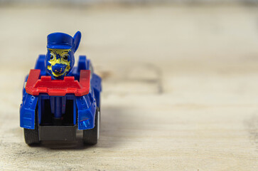 Old toy car on wooden construction background