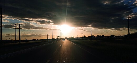 Fototapeta na wymiar sunset, road at sunset, highways at sunset