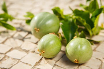 Green Passiflora fruit. Passion fruit on stone surface