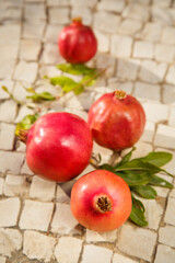 Green pomegranate fruit. Garnet fruit on stone surface