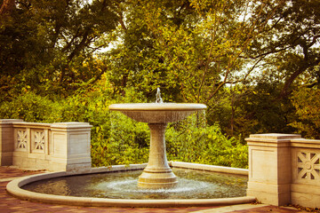 garden fountain monument in a park surrounded by trees