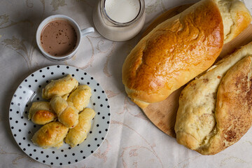 Homemade bread with milk and hot chocolate aside.