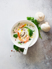 Bowl of shrimp, broccoli and mushrooms cream soup