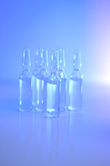 Medicine and Pharmacology.Biotechnology and Science.Glass transparent ampoules set in light blue  tones.Ampoules with solution for injection.Health and beauty.Organic natural cosmetics 