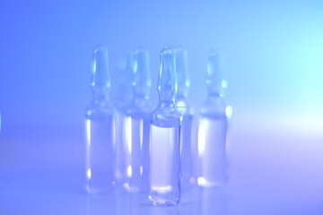 Medicine and Pharmacology.Biotechnology and Science.Glass transparent ampoules set in light blue and purple tones.Ampoules with solution for injection.Health and beauty.Organic natural cosmetics 