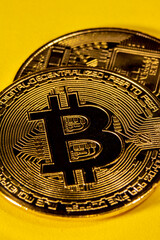 Fototapeta na wymiar Close-up of gold Bitcoin coins on yellow background.