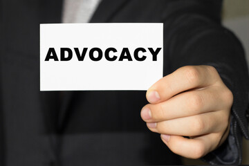Card with text ADVOCACY on hand. You can use in business, marketing and other concepts. Messege of the day.