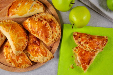 Apple pies on a wooden plate. Homemade cakes