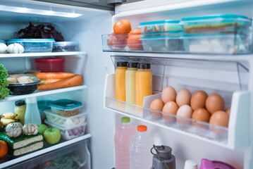 open fridge door with full of food and ingredient inside
