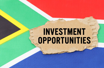 On the flag of South Africa lies a cardboard box with the inscription- INVESTMENT OPPORTUNITIES