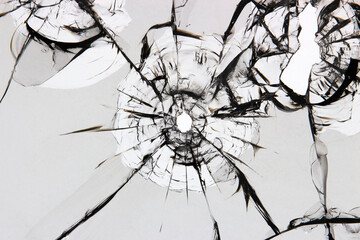 Crack texture on broken glass. A shot in the glass, a hole from a bullet