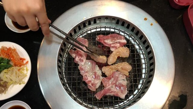 meat is grilling on charcoal stove