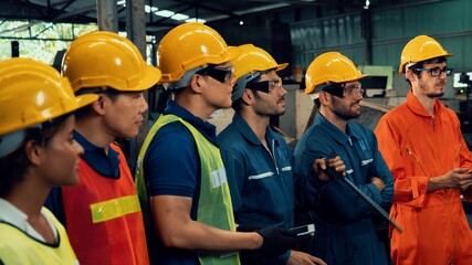 Skillful worker attending brief meeting in the factory . Industrial people and manufacturing labor concept .
