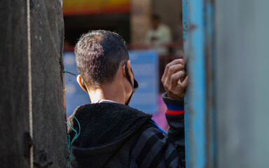 K.R.Market, Bangalore, India - February 06,2021: Young indian man looking aside in the streets of krmarket