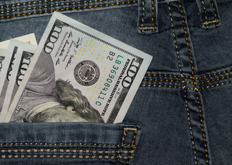 money in your pocket. dollar bills in the back pocket of my jeans. The concept of pocket money. Cash. American money, denominations 100. business, trade or financial transactions. close-up
