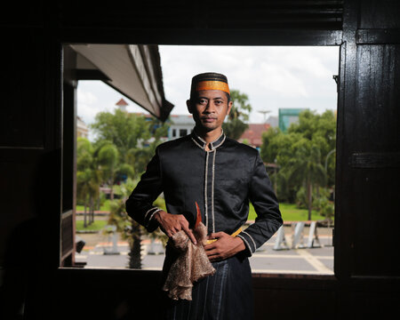 Men in black wear traditional Makassar Bugis clothes