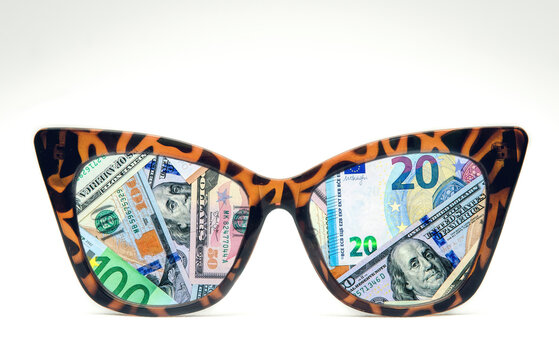 Consumerism, business and greed concept. Glasses and money