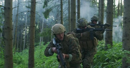 Millitary operation with gorup of soliders attacking enemy line in dense forest during day time