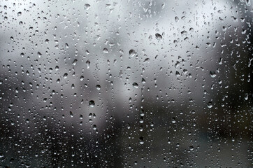 On a spring raining day. Drops of water on the window