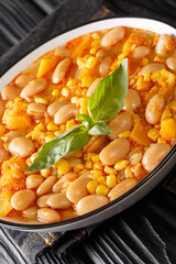Chilean Bean Stew Porotos Granados close up in the bowl on the table. Vertical