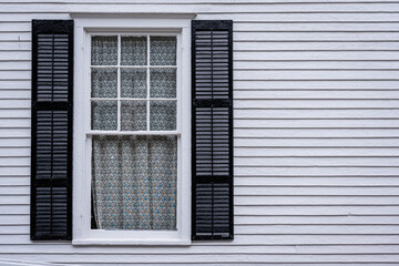 Fototapeta premium window with open shutters of an light colored wooden house