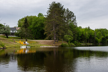 Fototapeta na wymiar small seaplane moored near the shore of a mountain lake. Adirondacks, NY