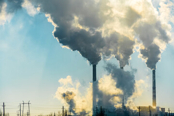 Sunset over the industrial city.Factory chimneys smoke.Environmental problem of environmental and...