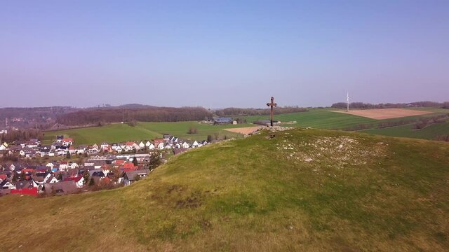 Piusberg with wood cross from a higher position in the city of Warstein, Sauerland region, Germany