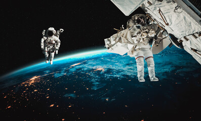 Astronaut spaceman do spacewalk while working for space station in outer space . Astronaut wear...