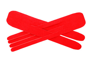 Red kinesio tape pieces on white background, top view