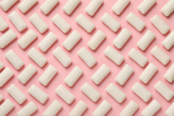 Many chewing gum pieces on pink background, flat lay