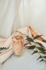 glass of coffee with milk on a white canvas