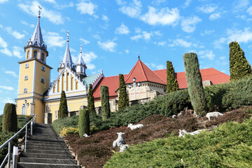 Fototapeta na wymiar TRZCIANA, POLAND - MARCH 31, 2021: Church and beautiful alpine garden