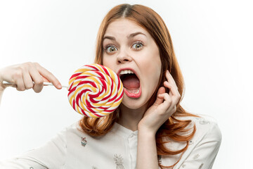 woman with multicolored lollipop near face cropped view of sweets emotion with open mouth