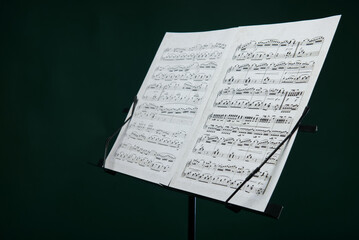 Fototapeta na wymiar Music notes on a music stand on a dark background